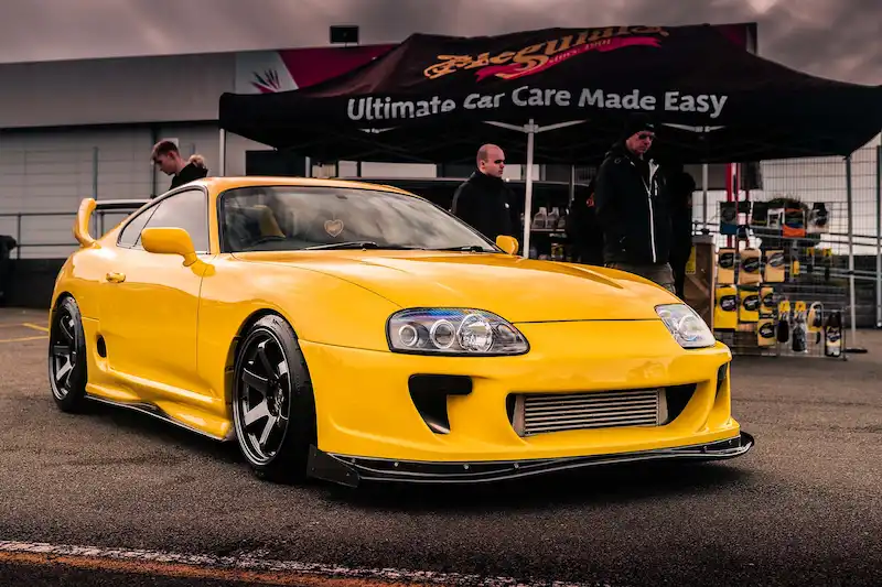 Yellow Toyota Supra at Meguiar's stand, TRAX Silverstone 2021
